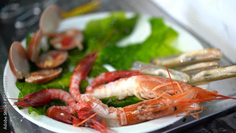 Fresh Seafood Market In Cinque Terre, Italy. Male seller Prepare fresh seafood on the plate for the buyer. 4K Fresh Seafood Market In Cinque Terre, Italy. Male seller Prepare fresh seafood on the plate for the buyer. 4K