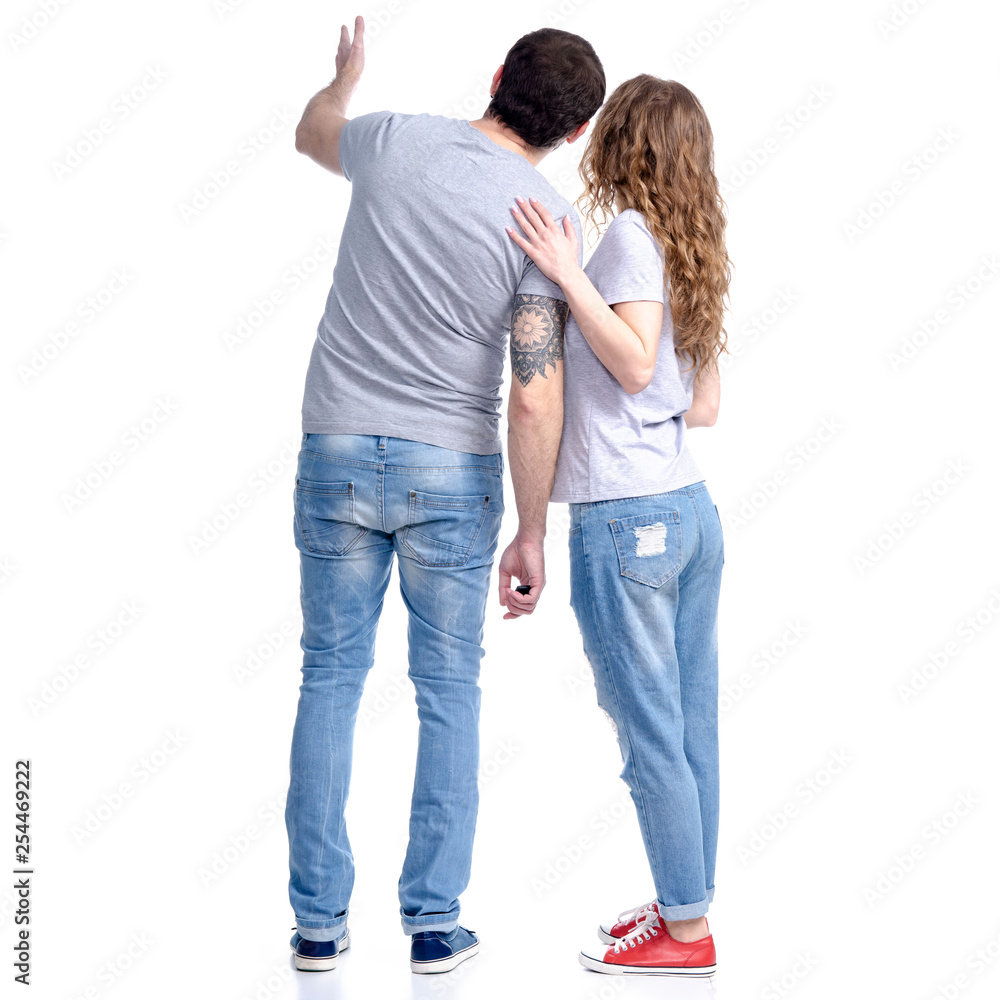Woman and man in jeans standing looking showing on white background isolation, rear view Woman and man in jeans standing looking showing on white background isolation, rear view