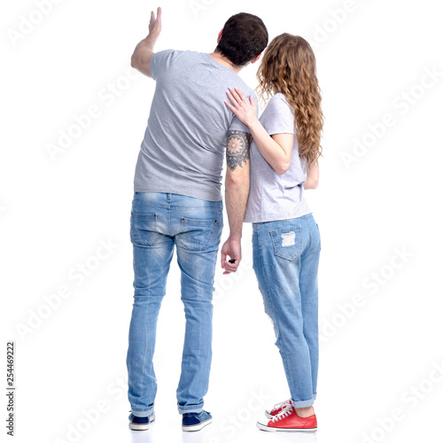 Woman and man in jeans standing looking showing on white background isolation, rear view