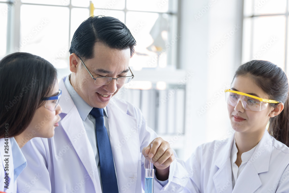 Asian senior laboratory scientist man working at lab with asian young student scientist backgroud. Asian senior laboratory scientist man working at lab with asian young student scientist backgroud.