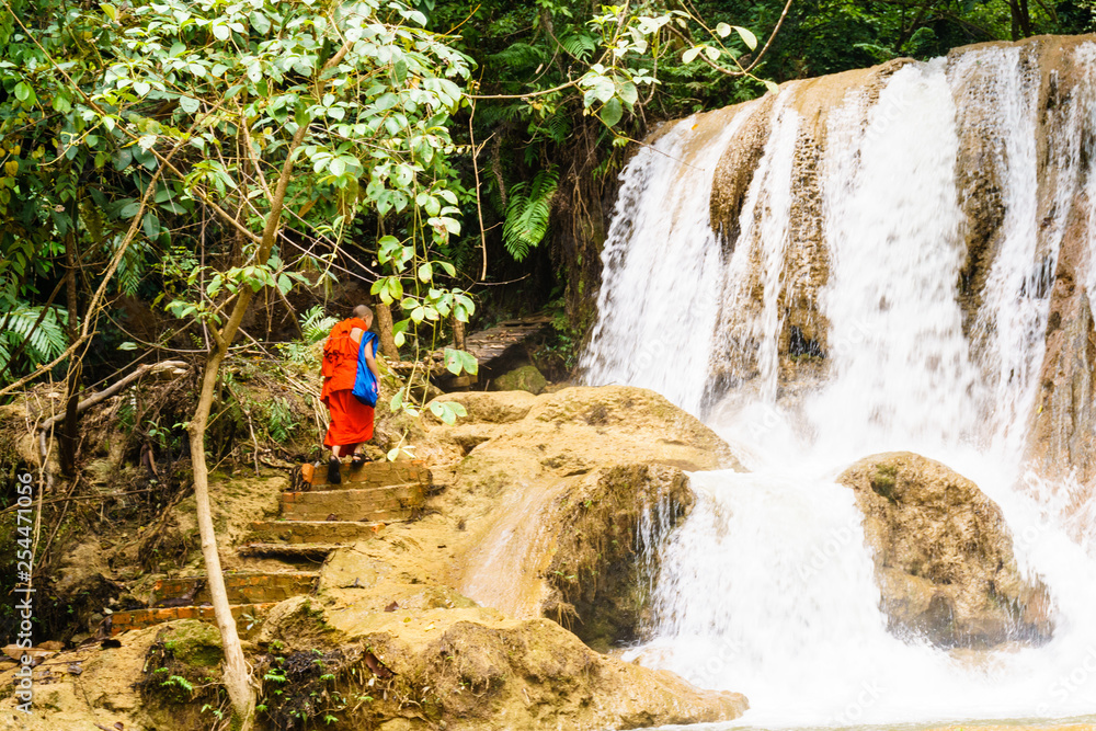 A monk on a mountain waterfall A monk on a mountain waterfall