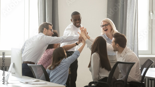 Happy diverse employees business team engaged in teambuilding giving high-five