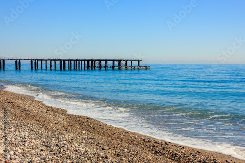 Mediterranean landscape in Antalya  Turkey. Blue sea  pier and mountains.