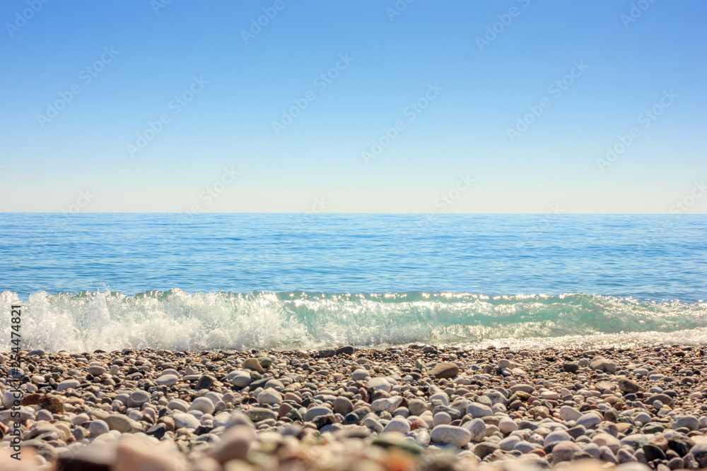 Mediterranean landscape in Antalya, Turkey. Blue sea, waves and pebble sandy beach
