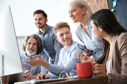 Business people discussing work matters at table in office. Professional communication