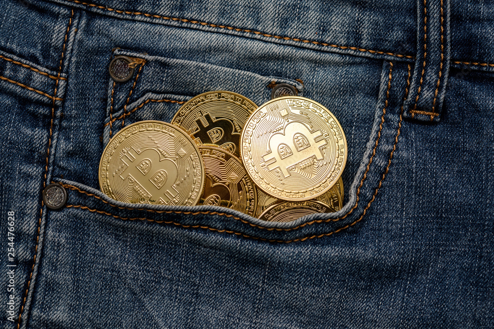Bitcoin cryptocurrency in the pocket of jeans. Concept with bitcoin. Bitcoin cryptocurrency in the pocket of jeans. Concept with bitcoin.