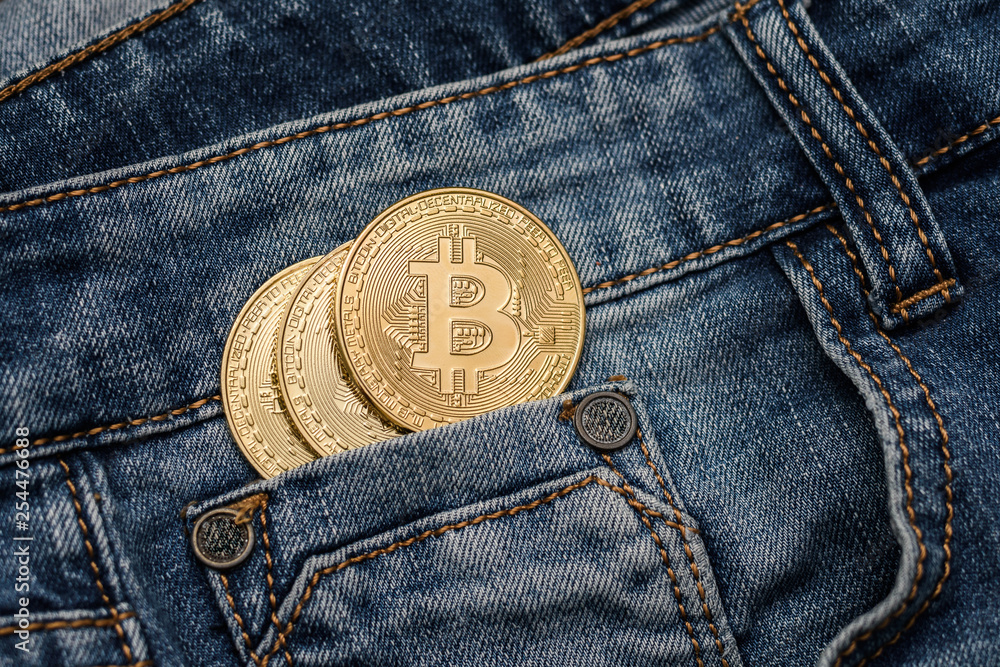 Bitcoin cryptocurrency in the pocket of jeans. Concept with bitcoin. Bitcoin cryptocurrency in the pocket of jeans. Concept with bitcoin.