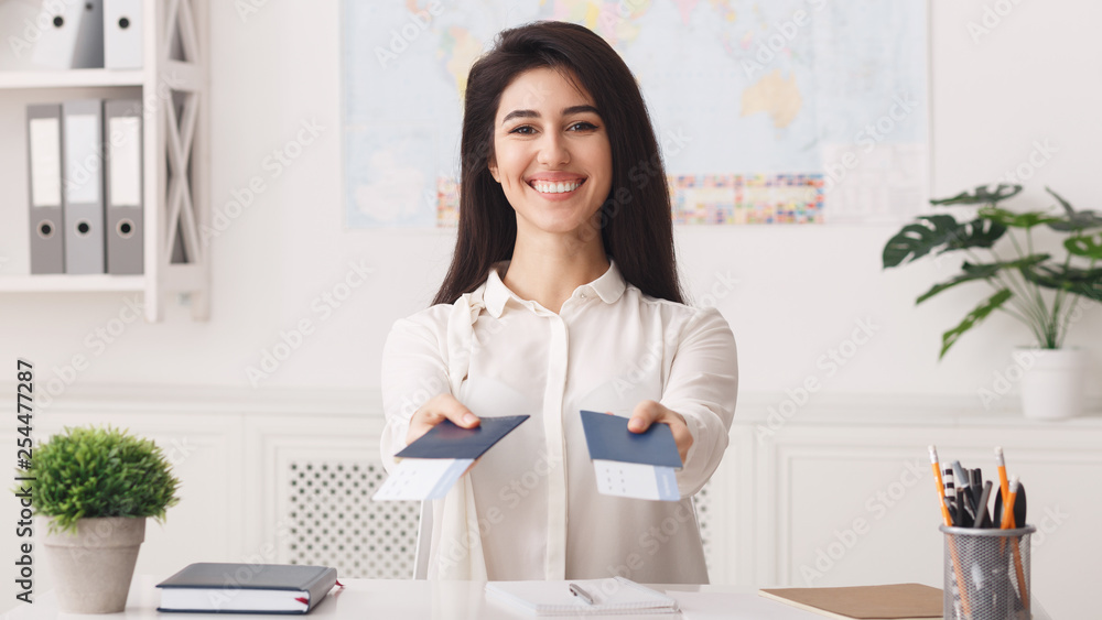 Happy travel agent stretches passports with tickets Happy travel agent stretches passports with tickets