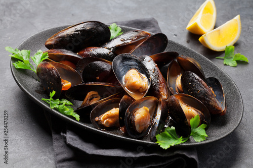 Delicious mussels with tomato sauce and parsley photo