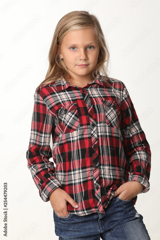 Portrait of a girl with long blond hair wearing a plaid shirt. White background Portrait of a girl with long blond hair wearing a plaid shirt. White background