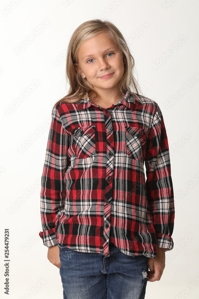 Portrait of a girl with long blond hair wearing a plaid shirt. White background Portrait of a girl with long blond hair wearing a plaid shirt. White background