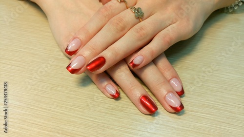 Beautiful female hands with a red nail design