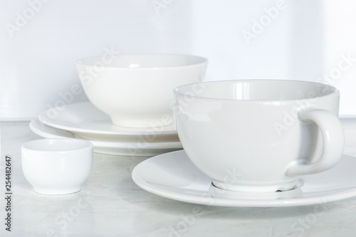 Wallpaper Mural set of white dishes. empty cup bowls plates on the table soft focus Torontodigital.ca