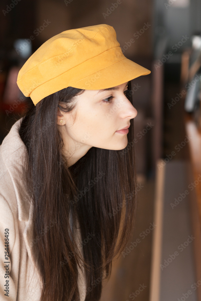 A visitor to the cafe where the self-service, the woman who stands opposite the waiter and makes an order, points to the position on the menu A visitor to the cafe where the self-service, the woman who stands opposite the waiter and makes an order, points to the position on the menu