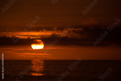 Sun behind clouds on a fired sky 6
