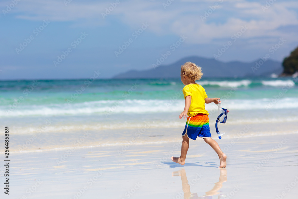 Child snorkeling on tropical beach. Kids snorkel.