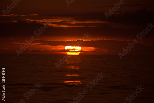 Sun behind clouds on a fired sky 4