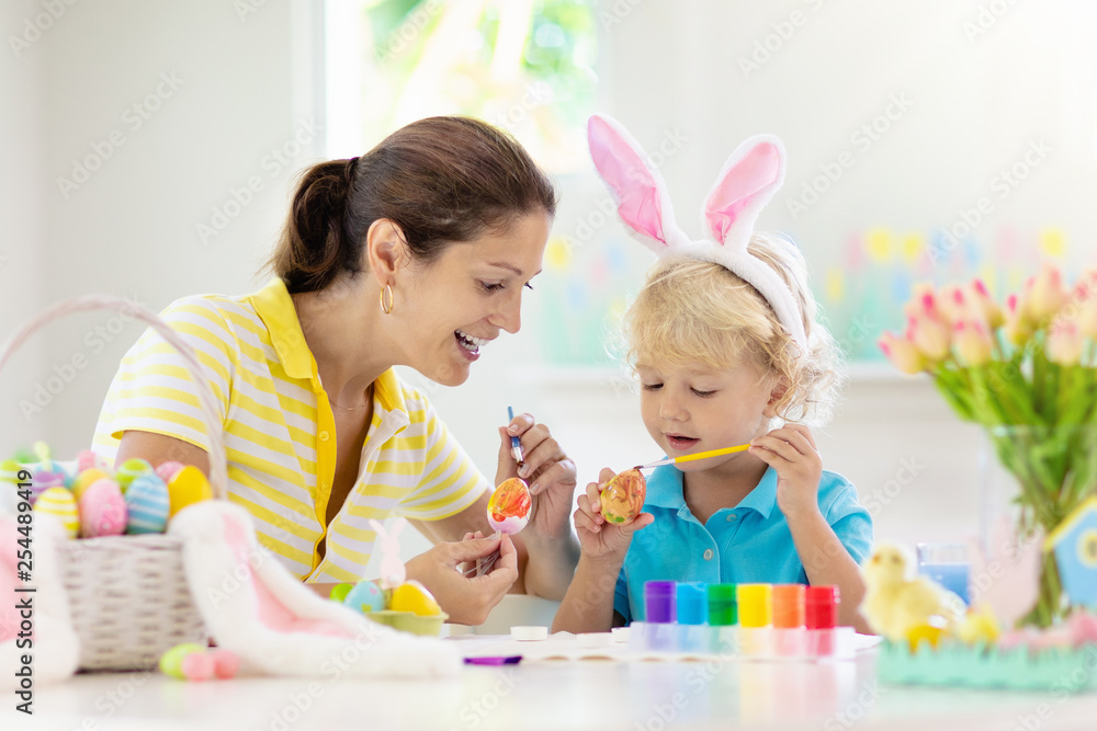 Mother and kids, family coloring Easter eggs. Mother and kids, family coloring Easter eggs.