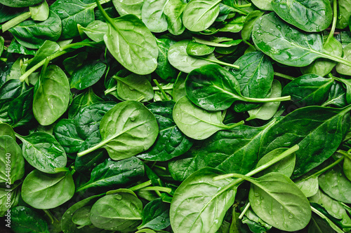 Top view on fresh organic spinach leaves. Healthy green food and vegan background. photo