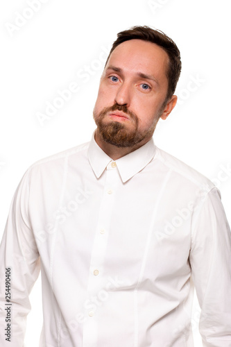 Handsome bearded man in a white shirt poses, isolated on a white background © nazarovsergey