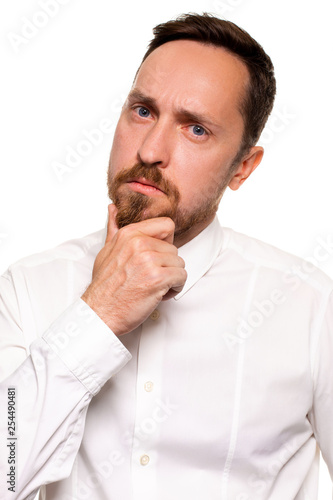 Handsome bearded man in a white shirt poses, isolated on a white background