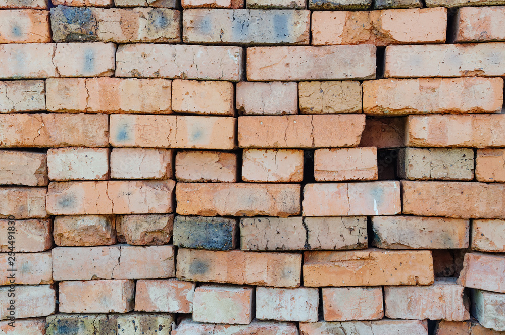 Obraz premium A stack of red old bricks texture. Clay brick used for construction.
