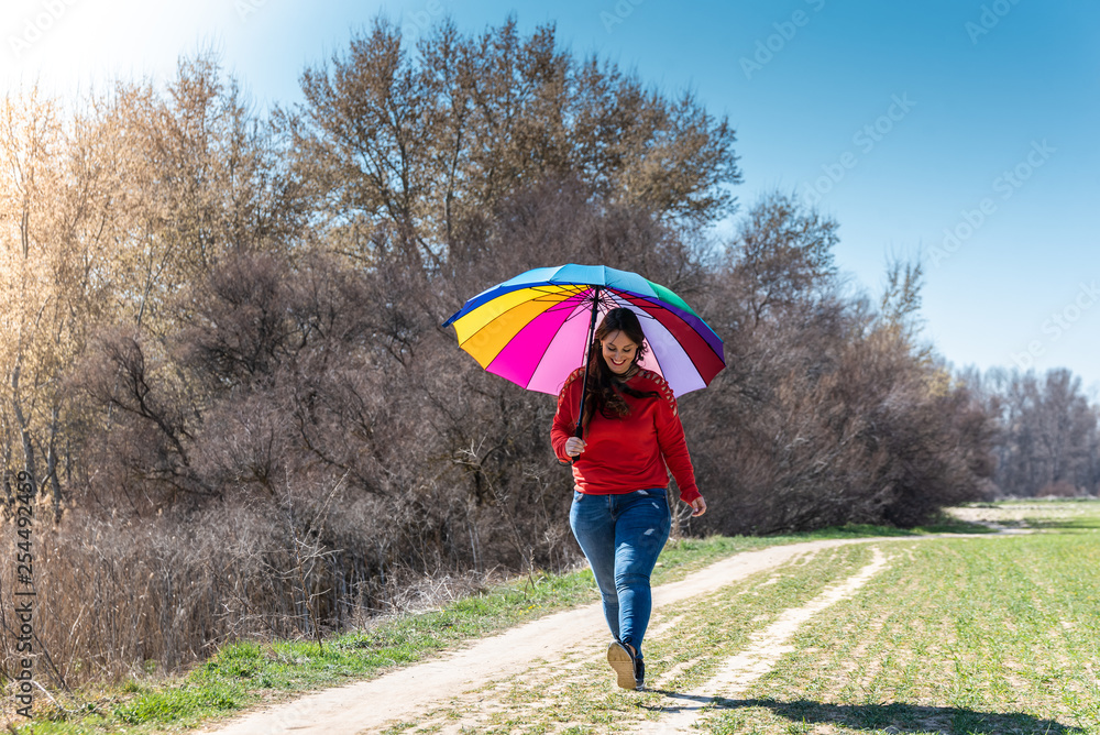 Young Woman Walking and Having Fun with an Umbrella. Young Woman Walking and Having Fun with an Umbrella.