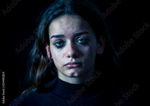 Portrait of sad, unhappy young girl crying. Helpless, depressed child. Stop bullying campaign