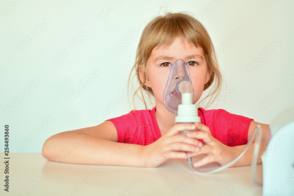 A little girl breathes a nebulizer. Little girl is being treated at