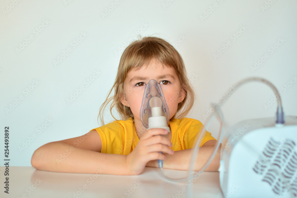 A little girl breathes a nebulizer. Little girl is being treated at