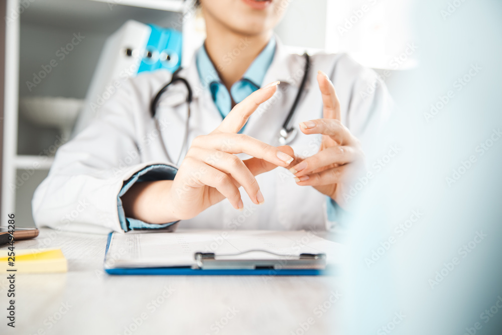 female doctor and patient discussing something while sitting at the table female doctor and patient discussing something while sitting at the table