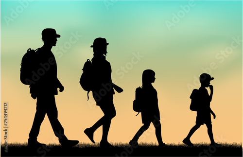 Family reaching with backpacks on a trip.