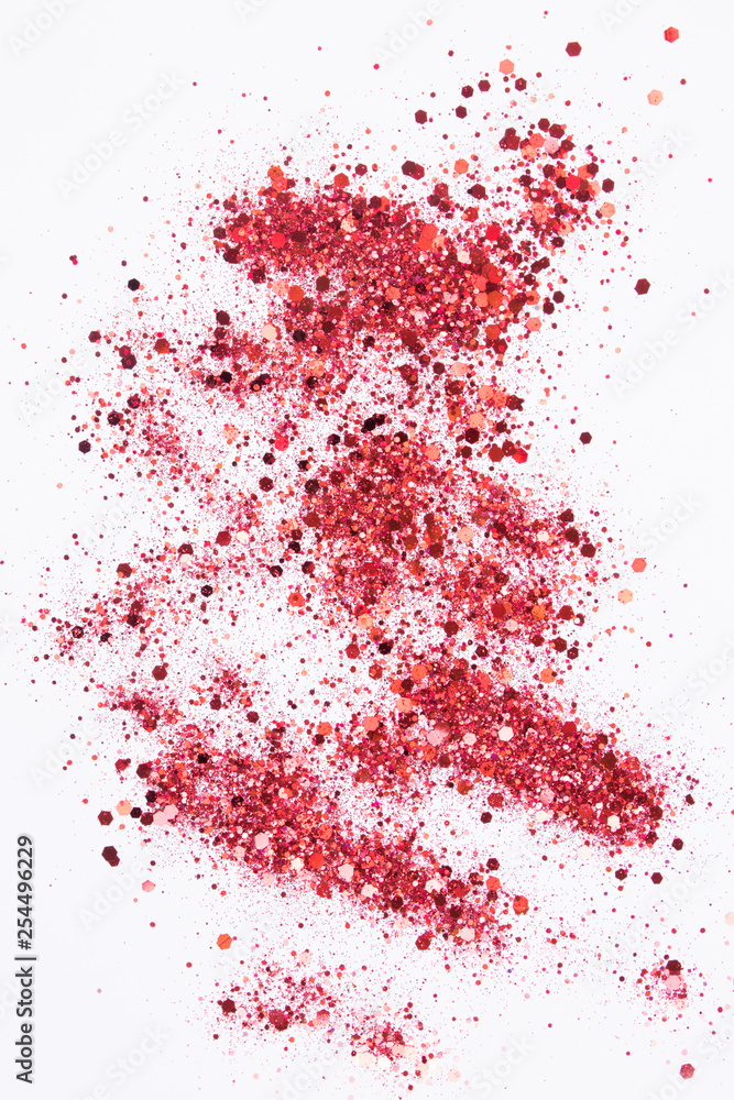 Red glitter on a white background. Background for your design.