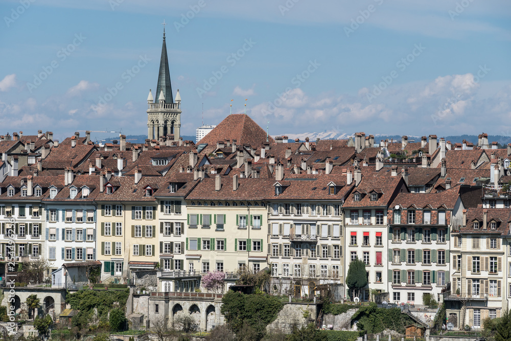 Bern skyline with houses from the old town on a cliff on a sunny day in Switzerland capital city