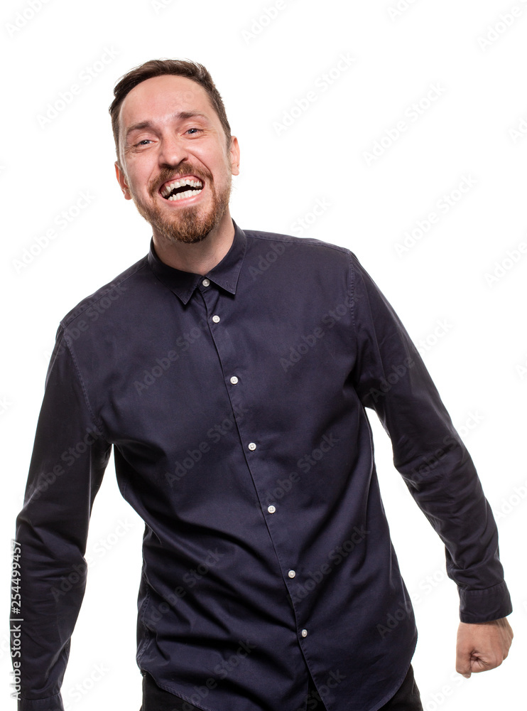 Portrait of a handsome, unshaven man, dressed in a dark blue shirt, standing against a white background. Self confident man. Portrait of a handsome, unshaven man, dressed in a dark blue shirt, standing against a white background. Self confident man.