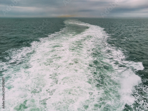 View from the back of a ferry crossing the English Channel, UK, Europe. Industrial/urban pollution from Portsmouth in the distance.