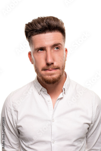 Studio photo of a good-looking man in a white shirt, isolated over a white background © nazarovsergey