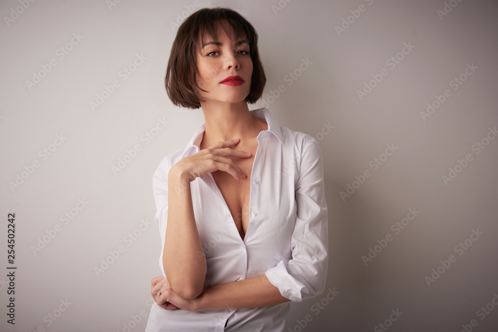 Fototapeta premium Studio portrait of beautiful young woman standing at isolated bacgkround