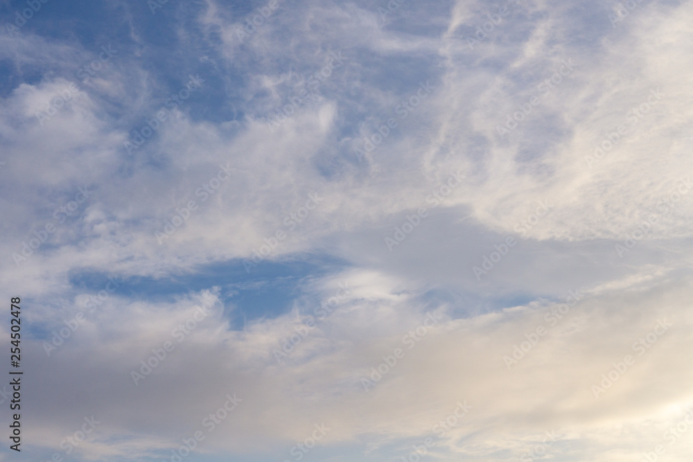Blue sky with clouds and sun reflection in water with place for your text. blue sky background with white clouds