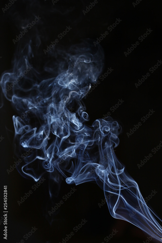 White and blue smoke on a black background. Sharp curls and smoke and out of focus. White and blue smoke on a black background. Sharp curls and smoke and out of focus.