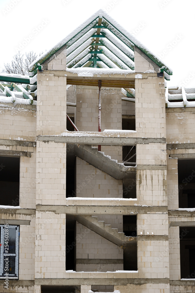 Obraz premium Internal stairs of stone house under construction in winter