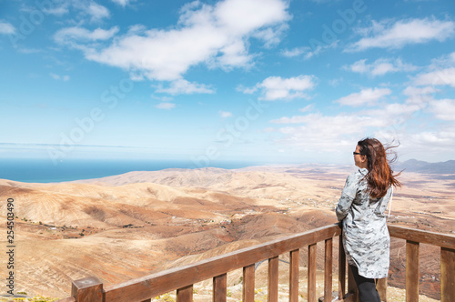 Принти на полотні Woman looking at volcanic mountains and ocean landscape from Mirador de Morro Ve