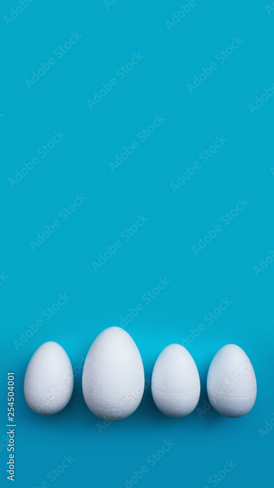 White foam eggs on blue background. Flat lay, top view. Easter concept. White foam eggs on blue background. Flat lay, top view. Easter concept.
