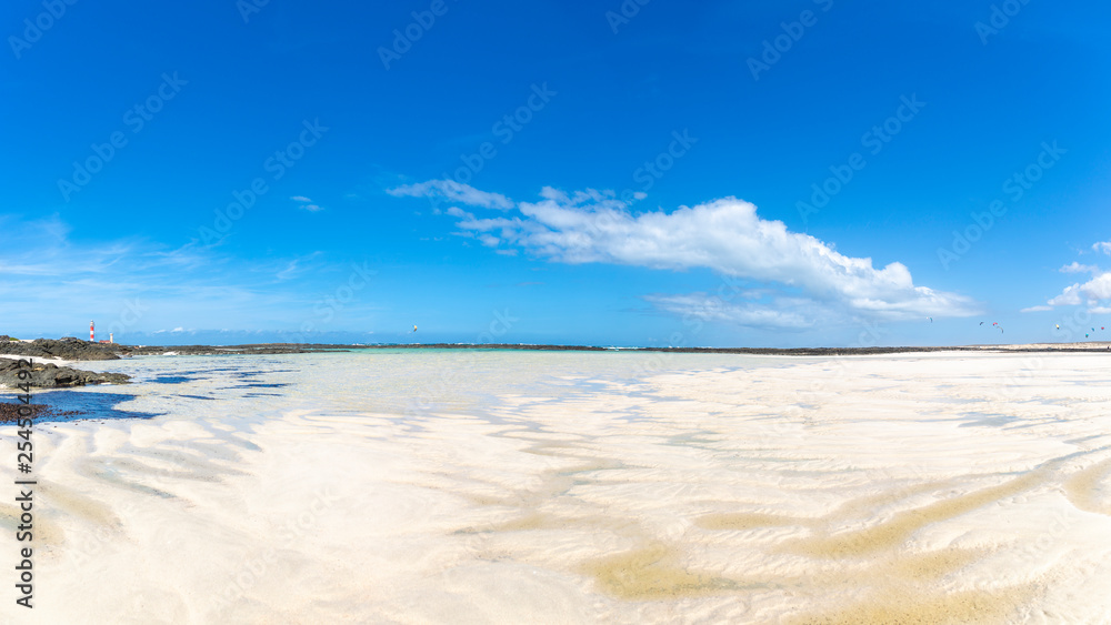 Fuerteventura, view of the Toston Lighthouse through Majanicho Bay and practice kite surfing