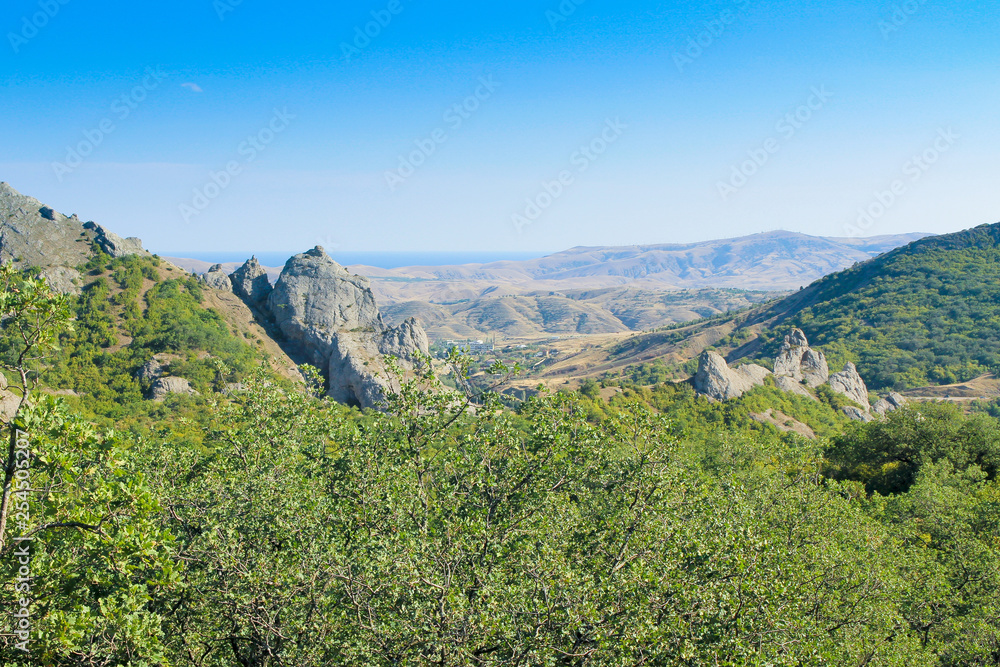 Landscape. Mountains, forest, sea and blue sky