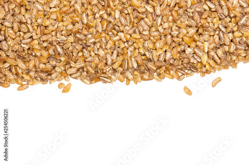 Lot of whole raw bulgur grains copyspace below flatlay isolated on white background