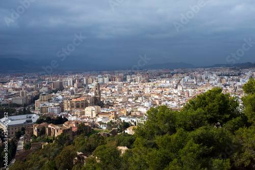 Malaga, Spain, February 2019. Panorama of the Spanish city of Malaga. Buildings  against a cloudy sky. Dramatic sky over the city. Beautiful view. © Лариса Люндовская