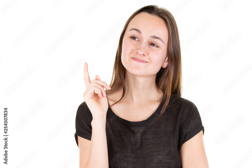 young woman pointing up at copyspace looks in camera young woman pointing up at copyspace looks in camera