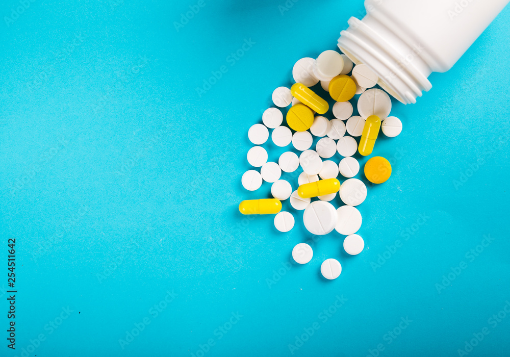 Assorted pharmaceutical medicine pills, tablets and capsules. Blue background. Assorted pharmaceutical medicine pills, tablets and capsules. Blue background.