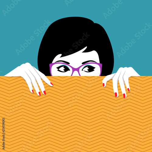 Woman hiding behind wall a watching